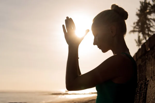 Woman in silhouette at the beach