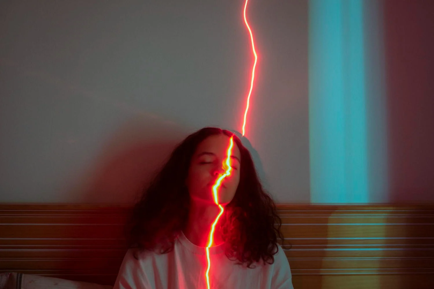 Red light beam piercing through a woman's energy field.