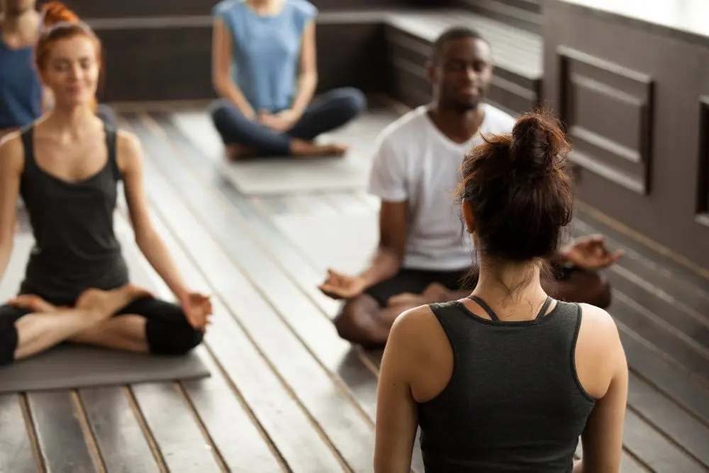 Group of people meditating in a yoga studio