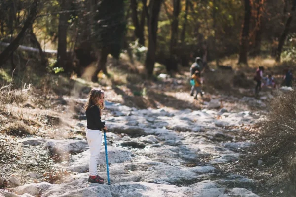 Girl hiking on a rocky forest path