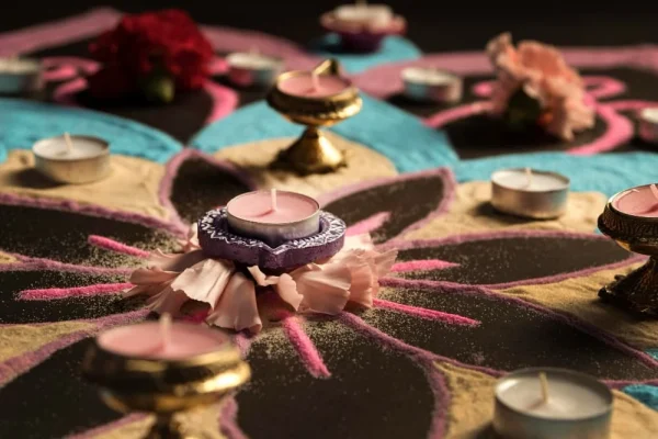 Colorful rangoli with candles and flower petals