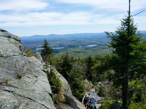 View with hikers climbing rocks on the looking glass rock trail