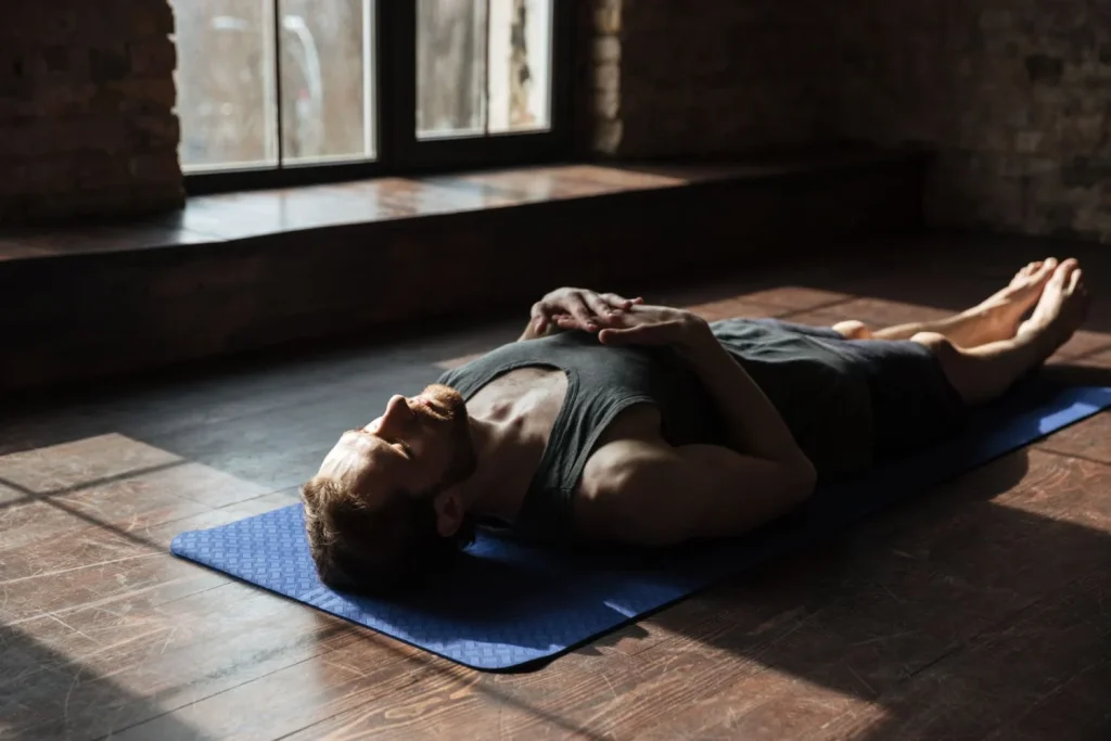 Man practicing Yoga Nidra in Shavasana