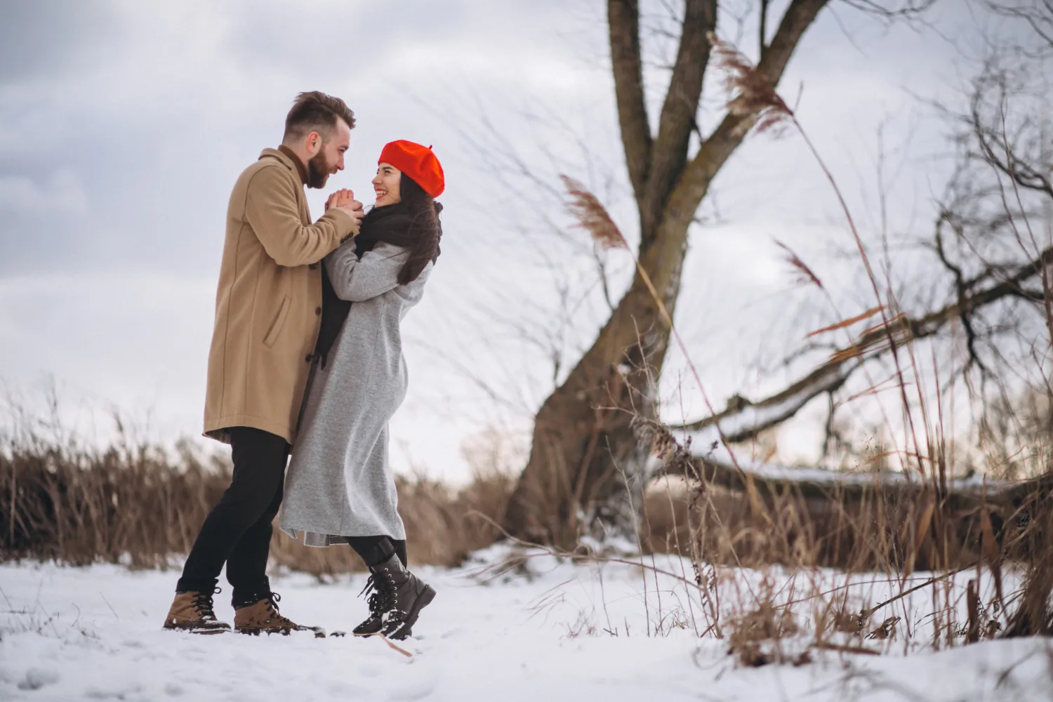 Couple embracing in the snow during a romantic getaway